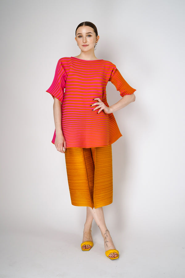 Pleats Please Issey Miyake Bounce Knit Short Sleeve Flared Top in Orange and Pink Vancouver. Shop Online or in Store.